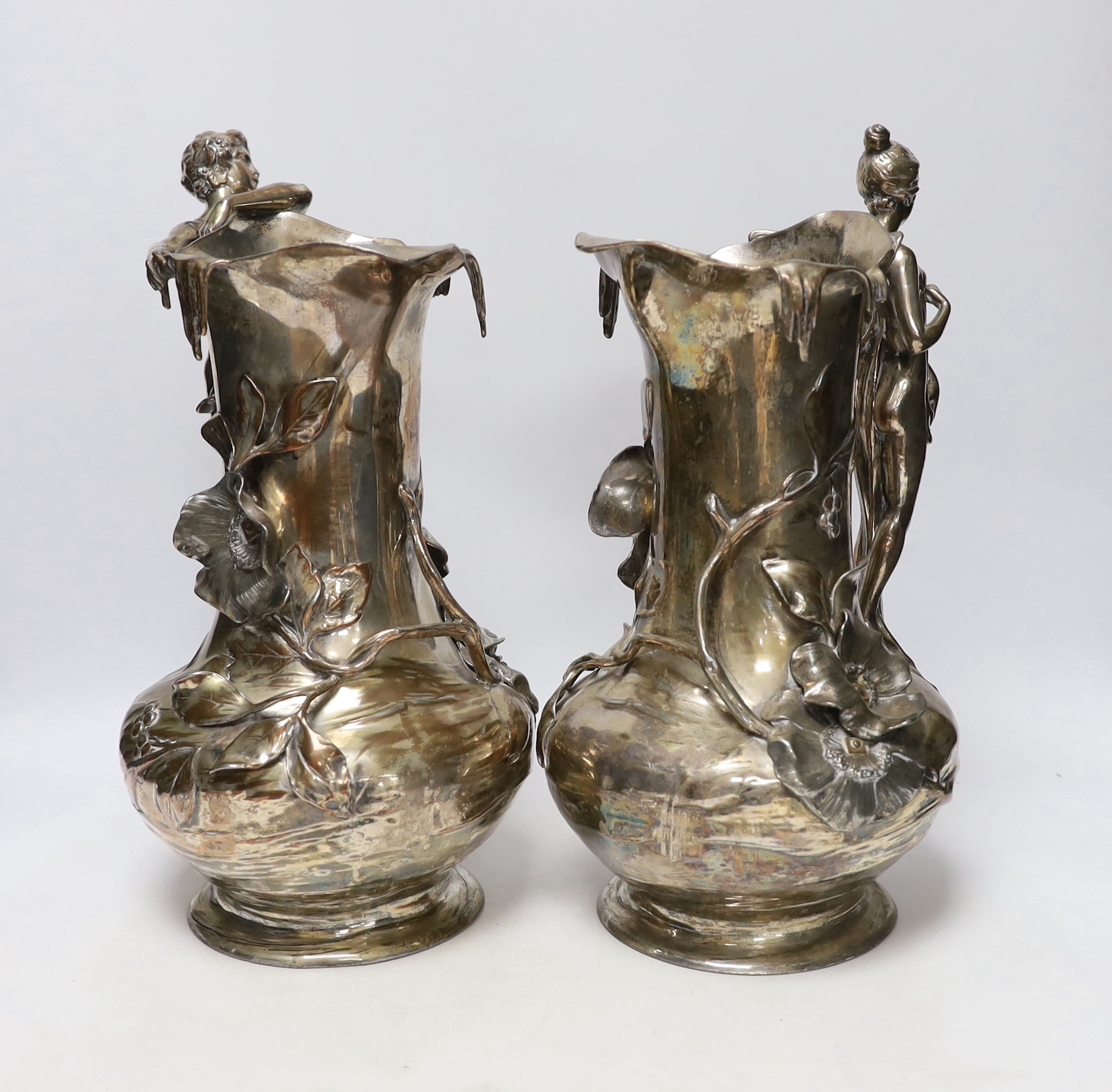 A pair of WMF Art Nouveau electroplated figural jugs and a similar mermaid jardiniere, unmarked, largest 35cm high